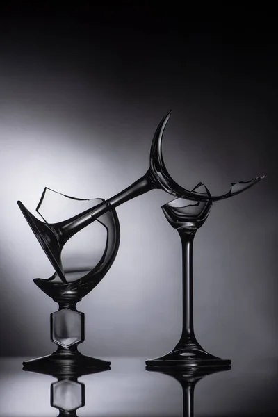Broken sharp glasses on dark black background — Stock Photo