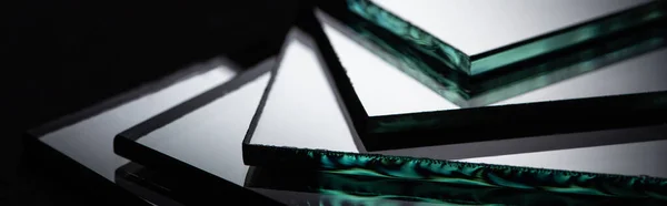 Close up view of mirror pieces in stack on black background, panoramic shot — Stock Photo