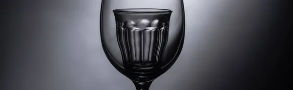 Close up view of shot glass in wine glass in dark, panoramic shot — Stock Photo