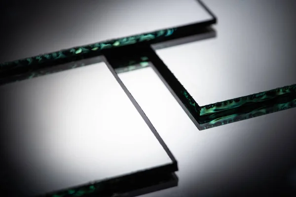 Close up view of square mirror pieces in stack in dark — Stock Photo
