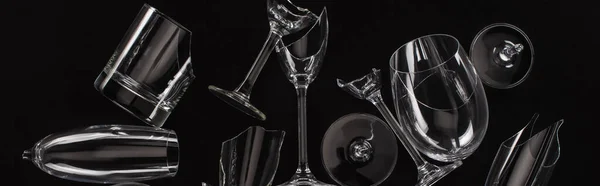 Top view of broken sharp transparent glasses isolated on black, panoramic crop — Stock Photo