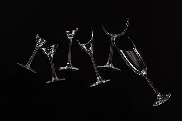 Broken sharp transparent glasses isolated on black — Stock Photo