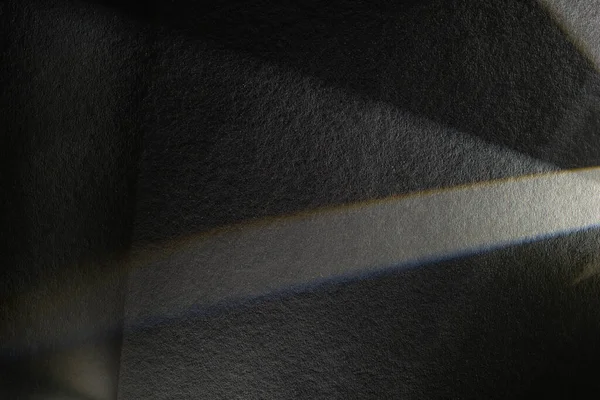 Light prism with beams on dark textured background — Stock Photo