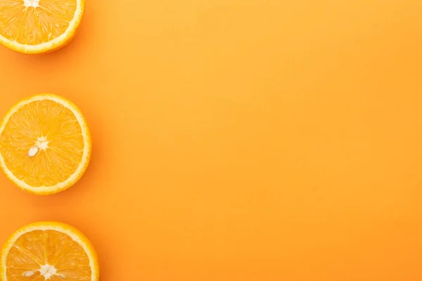 Vista superior de las rebanadas de naranja jugosas maduras sobre un fondo colorido con espacio para copiar - foto de stock