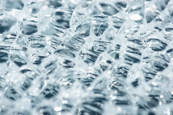 Close up view of abstract transparent ice textured background — Stock Photo