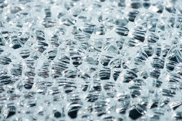 Close up view of abstract transparent ice textured background — Stock Photo