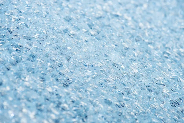Vue rapprochée du fond texturé abstrait de glace bleue — Photo de stock
