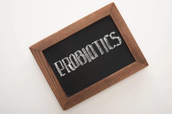 Top view of chalkboard with probiotics lettering on white background — Stock Photo