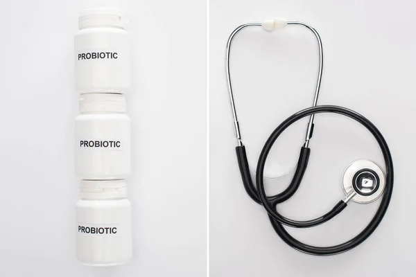 Collage de récipients avec lettrage probiotique près du stéthoscope sur fond blanc — Photo de stock