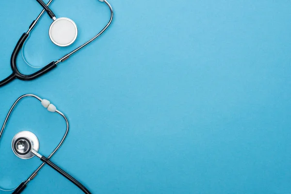 Top view of stethoscopes on blue background — Stock Photo