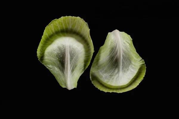 Top view of wet green cabbage leaves isolated on black — Stock Photo