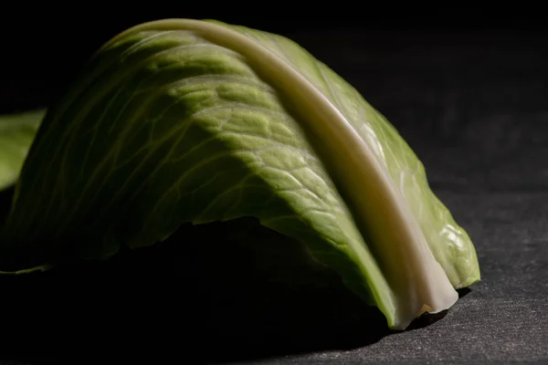 Close up view of green fresh cabbage leaf on black — Stock Photo