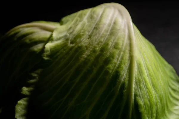 Close up view of green fresh cabbage leaves isolated on black — Stock Photo