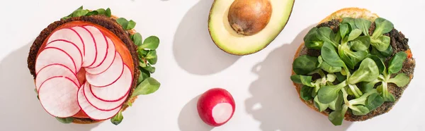 Top view of vegan burgers with microgreens, radish on white background, panoramic shot — Stock Photo