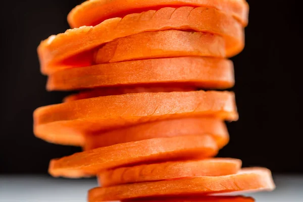 Close up view of fresh ripe carrot slices isolated on black — Stock Photo