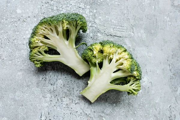 Top view of fresh green cut broccoli on grey surface — Stock Photo