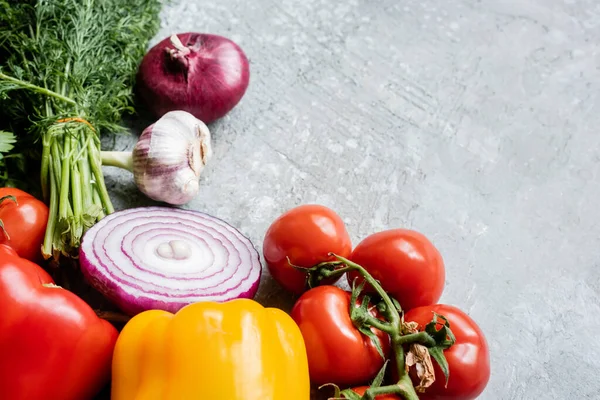 Colorful fresh ripe vegetables with knife on grey concrete surface — Stock Photo