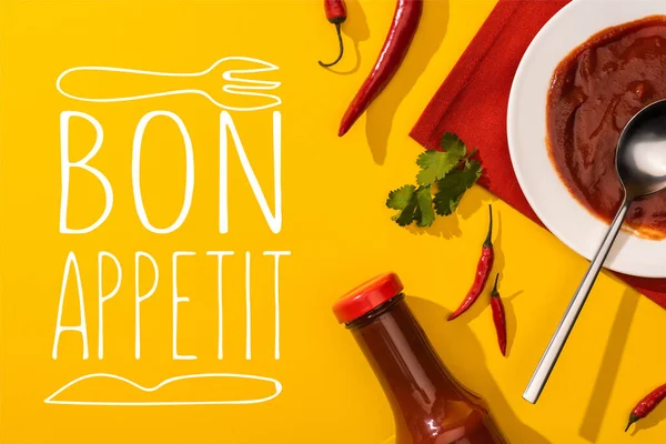 Top view of tomato sauce with hot chili peppers and cilantro on yellow background, bon appetit illustration — Stock Photo