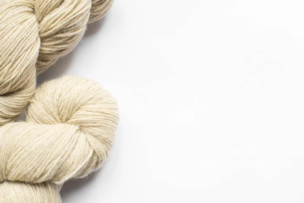 Beige yarn on white background with copy space — Stock Photo