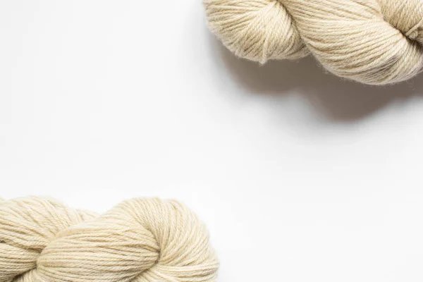 Beige yarn on white background with copy space — Stock Photo