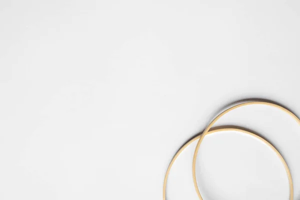 Top view of beige knitting looms on white background with copy space — Stock Photo