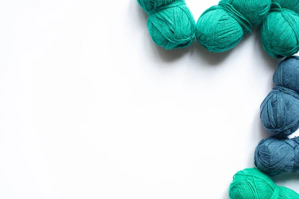 Top view of blue and green wool yarn on white background with copy space — Stock Photo