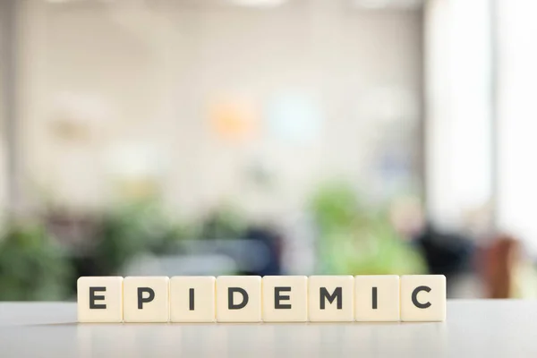 White cubes with epidemic lettering on white desk, covid-19 concept — Stock Photo