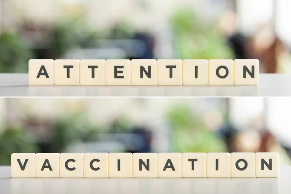 Collage of white cubes with attention, vaccination lettering on white desk, covid-19 concept — Stock Photo