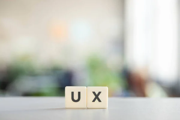 White blocks with ux lettering on office desk — Stock Photo