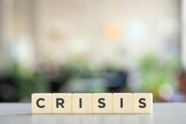 White cubes with world crisis on white desk in office — Stock Photo