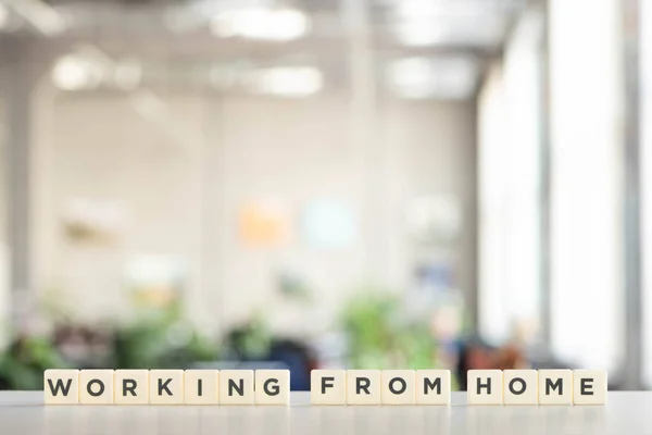 White cubes with working from home lettering on white desk — Stock Photo