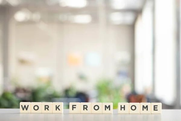 White cubes with work at home lettering on white desk in office — Stock Photo