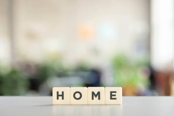 White blocks with home lettering on white desk in office — Stock Photo