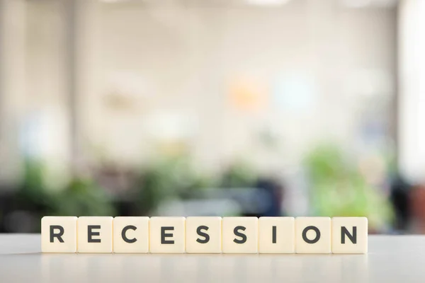 White blocks with recession word on office desk — Stock Photo