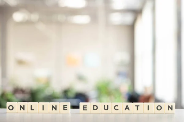White blocks with online education lettering on white desk — Stock Photo