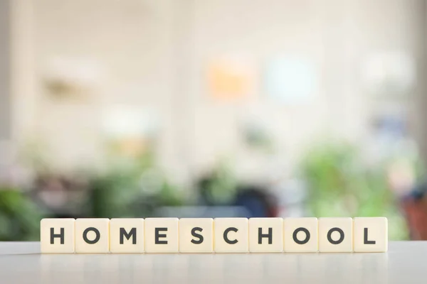 White blocks with homeschool lettering on white desk — Stock Photo