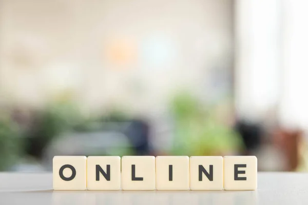 White blocks with online lettering on white desk in office — Stock Photo