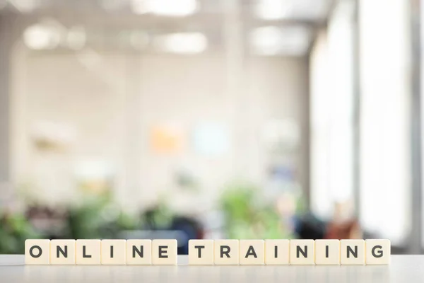 White blocks with online training lettering on white desk — Stock Photo