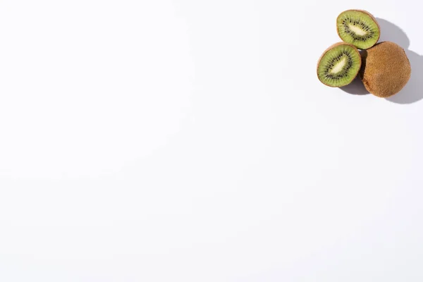 Top view of kiwi fruits on white with copy space — Stock Photo