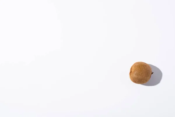 Top view of whole kiwi fruit on white with copy space — Stock Photo