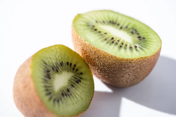 Close up of green kiwifruit halves on white — Stock Photo
