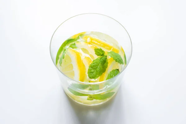 Fresh lemonade in glass with mint on white background — Stock Photo