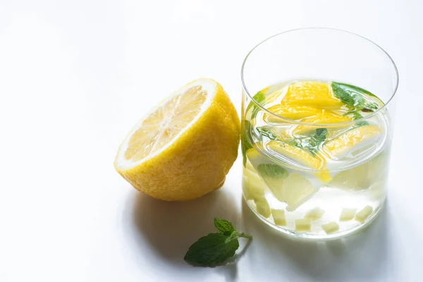 Fresh ginger lemonade in glass with lemon and mint on white background — Stock Photo