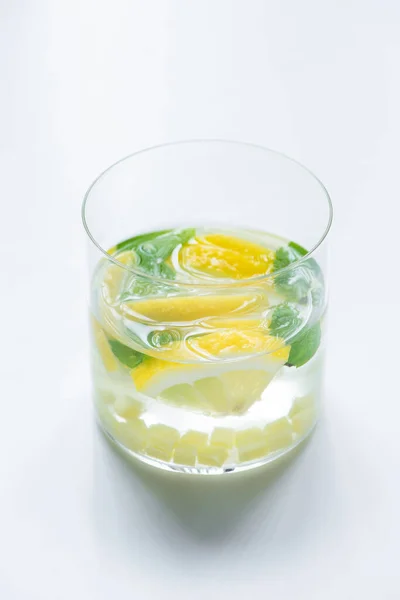Fresh ginger lemonade in glass with lemon and mint on white background — Stock Photo