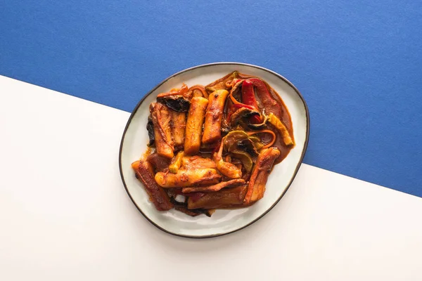 Top view of korean topokki on white and blue — Stock Photo