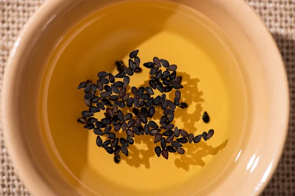 Top view of oil with black sesame in bowl — Stock Photo