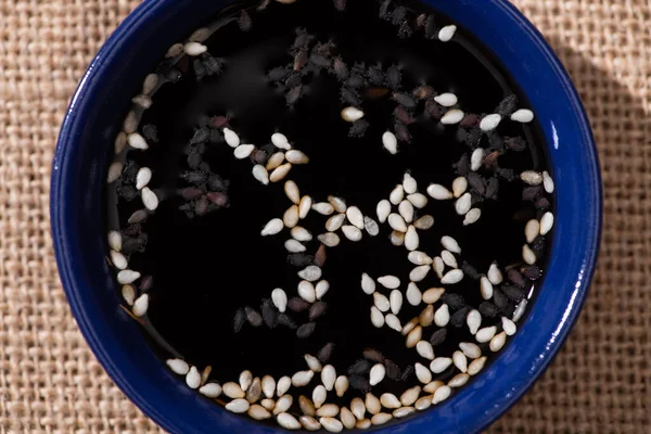 Top view of sesame in salty soy sauce — Stock Photo