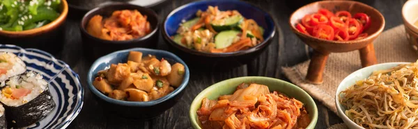 Horizontal crop of tasty korean dishes on wooden surface — Stock Photo