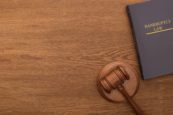 Top view of bankruptcy law book and gavel on wooden background — Stock Photo