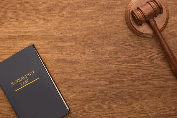 Top view of bankruptcy law book and gavel on wooden background — Stock Photo